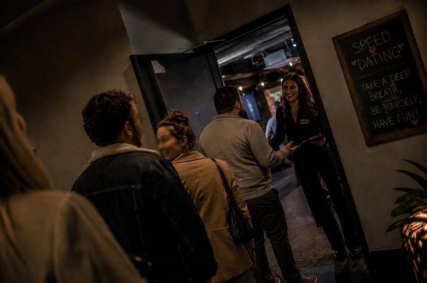 Guests being welcomed to a speed dating event